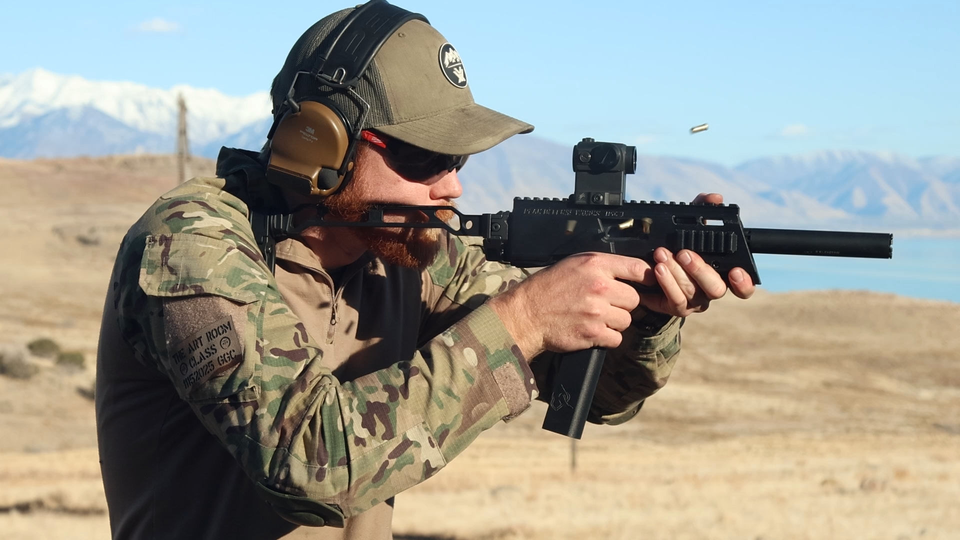 Shooter firing rifle with brass ejecting at The Art Room class